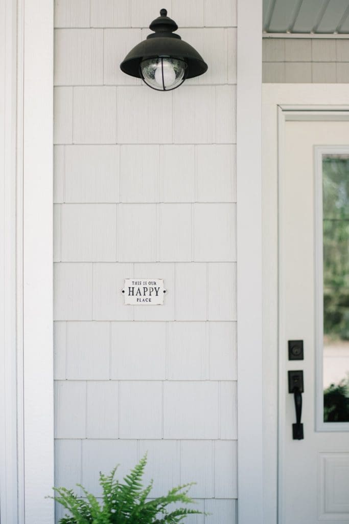 Sign beside front door that says this is our happy place