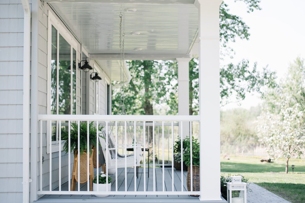 front porch with white railings and posts