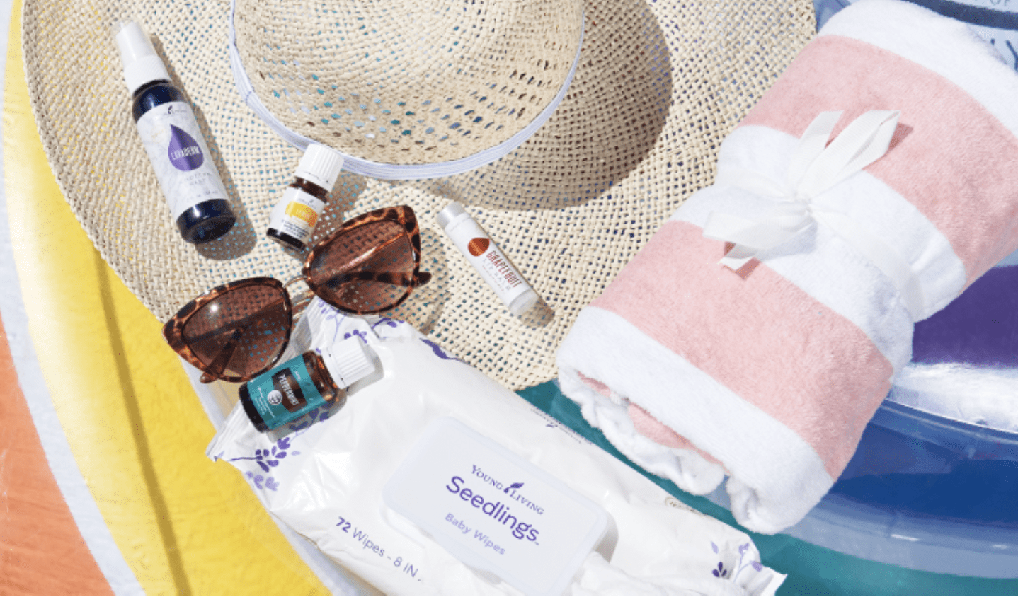 Young Living essential oil products for summer sitting on top of a sun hat