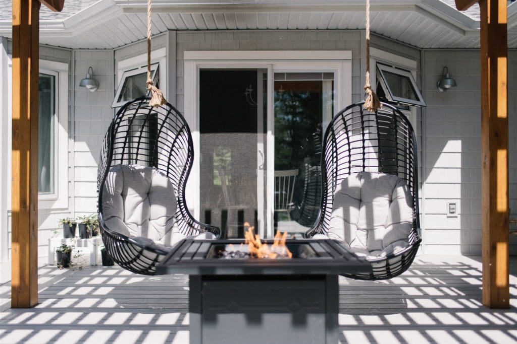 swinging chairs in front of an outdoor fire table