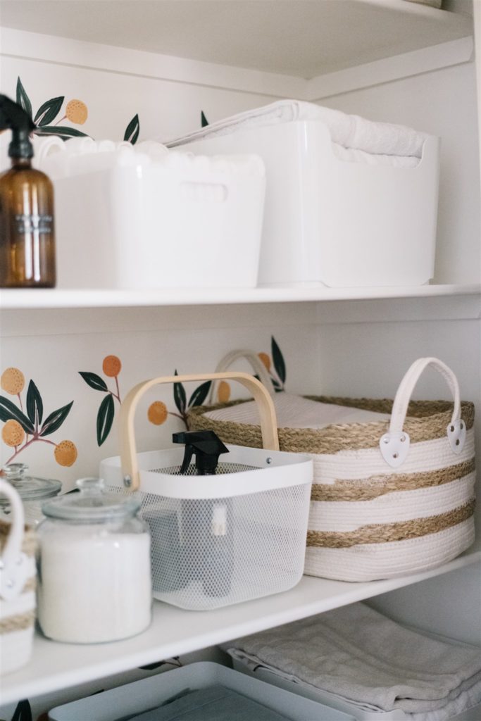 white bins and woven baskets on shelf