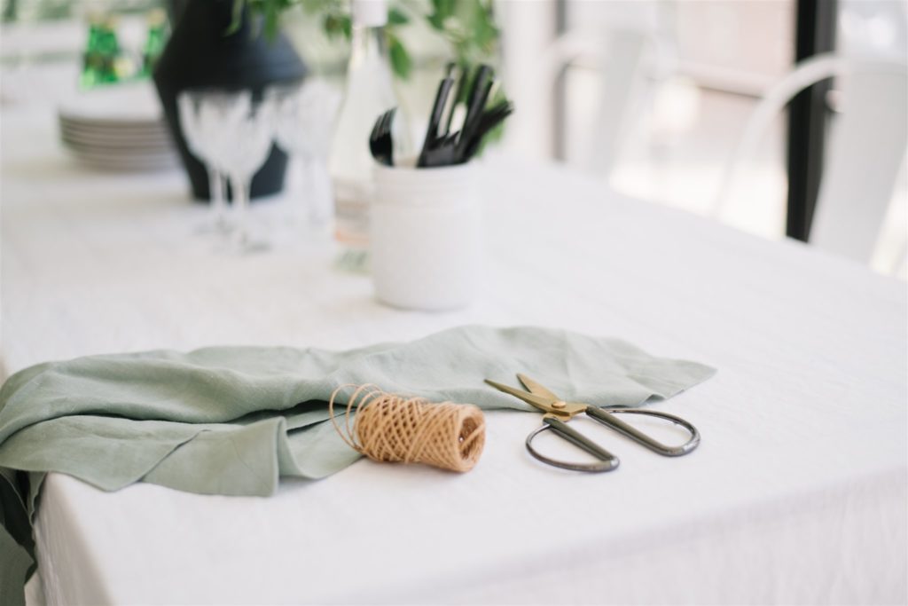 scissors and string sit on a green napkin