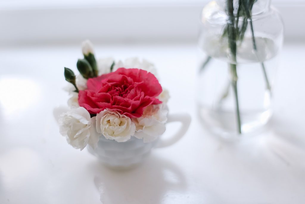 tiny sugar cup filled with flower blooms