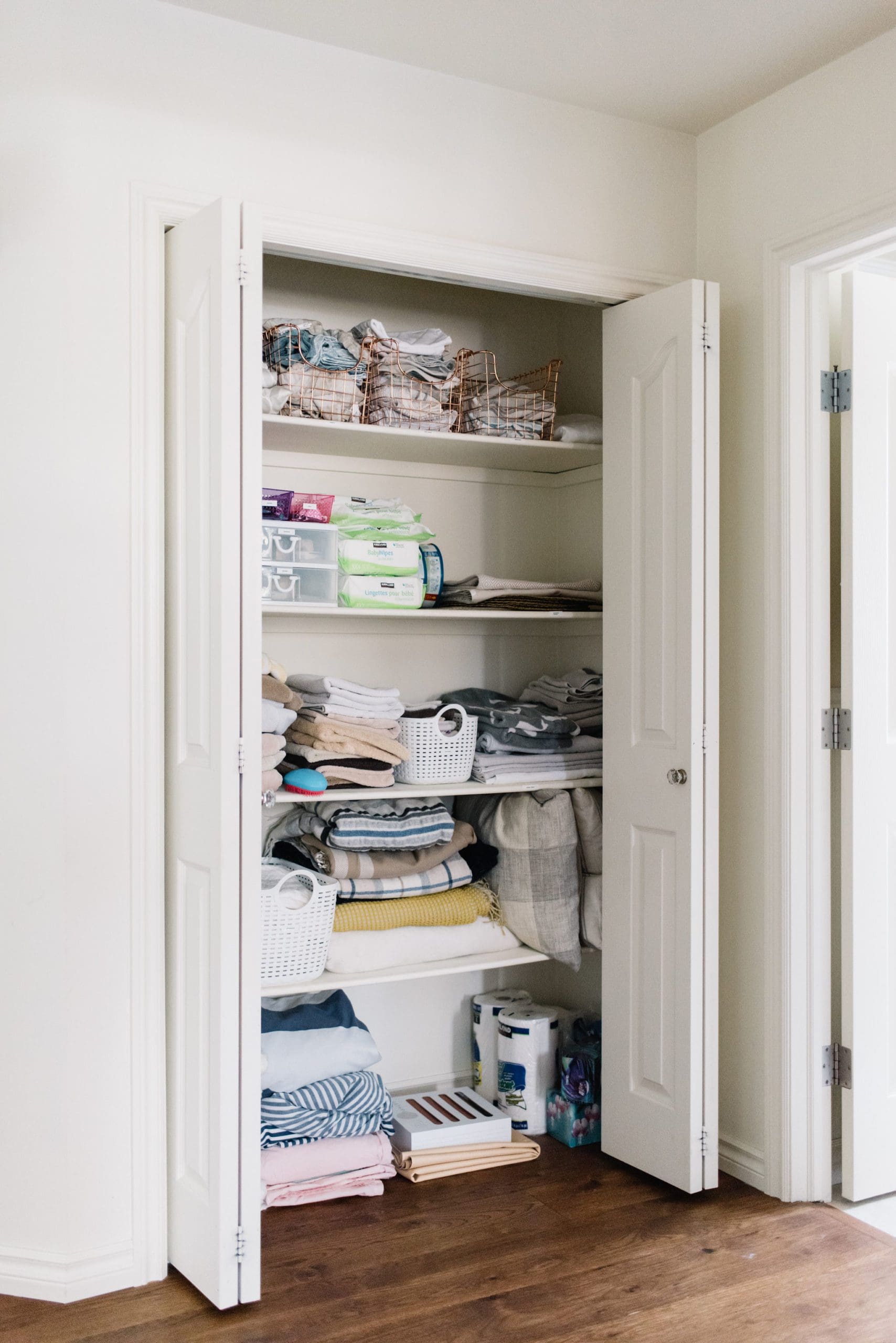 A Pretty & Functional Small Linen Closet Makeover - The Ginger Home