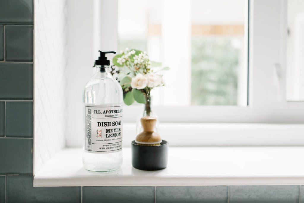 glass jar of handsoap on kitchen ledge
