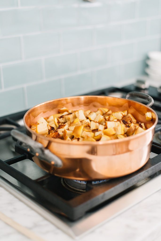 food on the stove in a copper pan