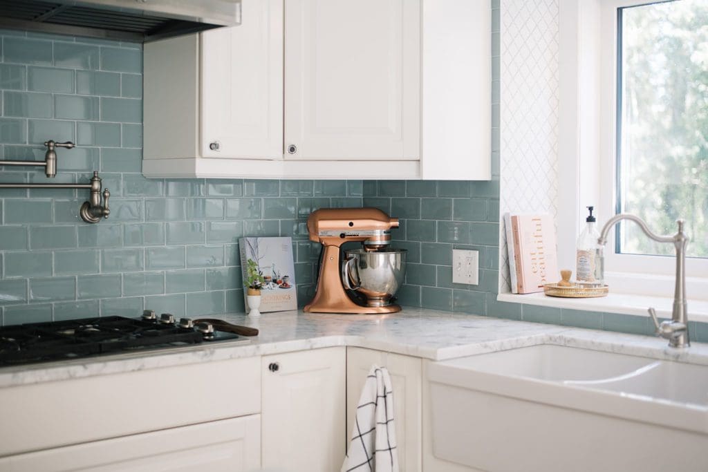 copper kitchen aid mixer sits on kitchen counter