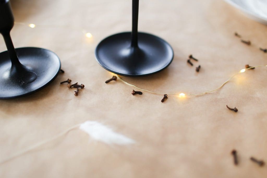 cloves sprinkled on the table with string lights