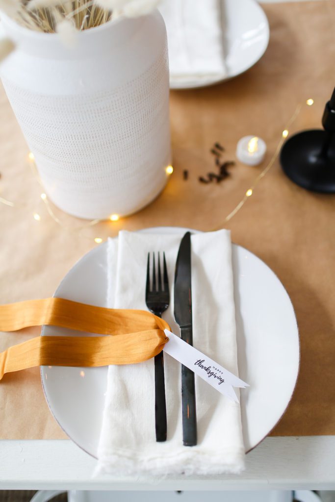 table setting with black cutlery and thanksgiving tags
