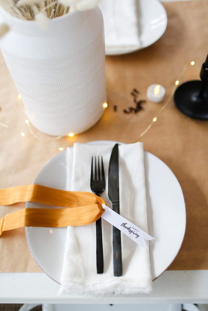 table setting with black cutlery and thanksgiving tags