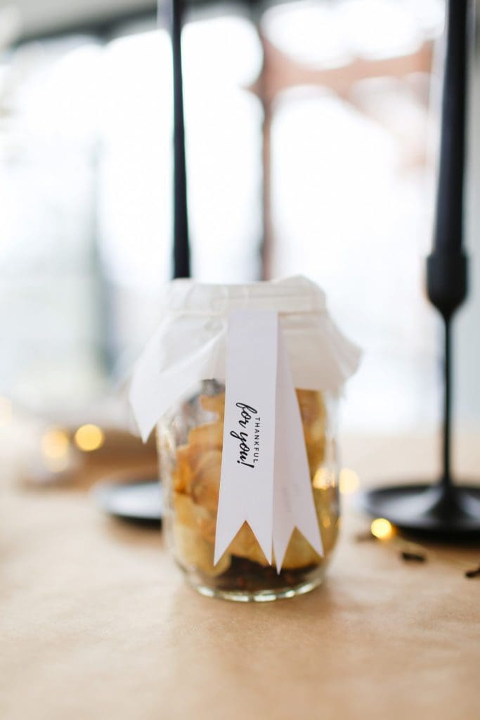 A close up of a glass cup on a counter, with thankful for you tags