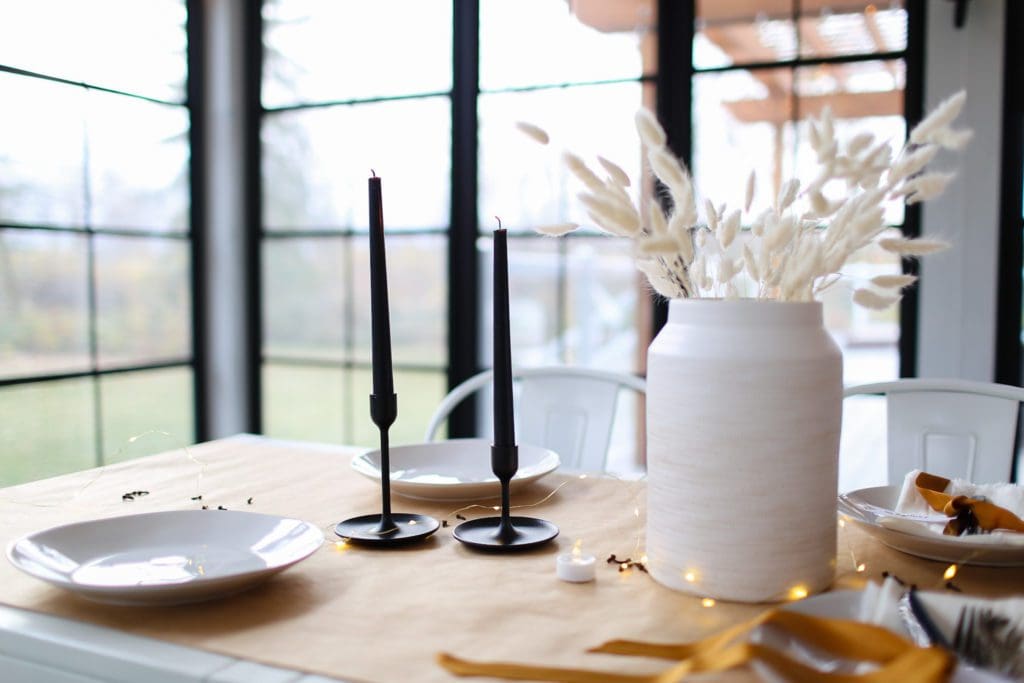 vase of dried bunny tails and black candles