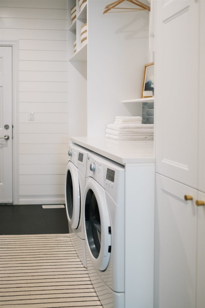 a washer and dryer with white stone countertop