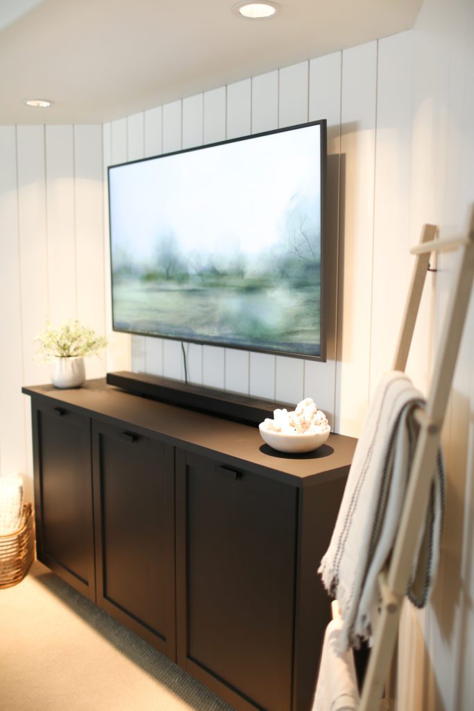 TV above black cabinet