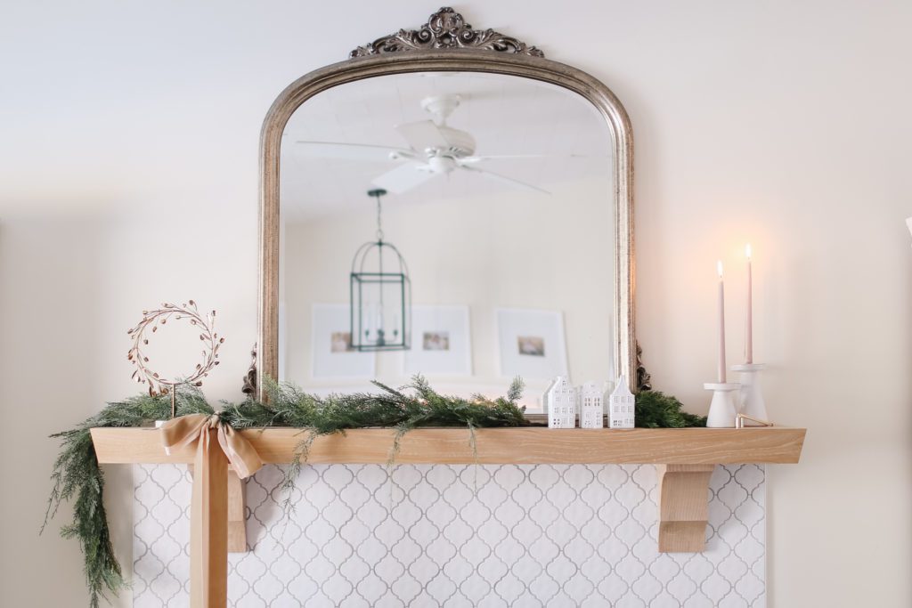 Christmas mantle with large mirror and greens