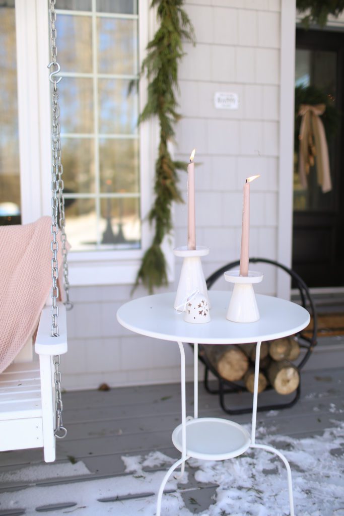 pink candles on an outdoor side table