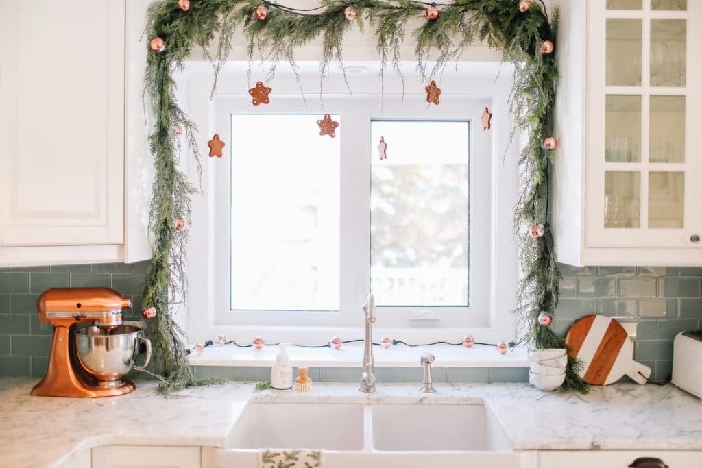 gingerbread cookie garland hung over a kitchen window