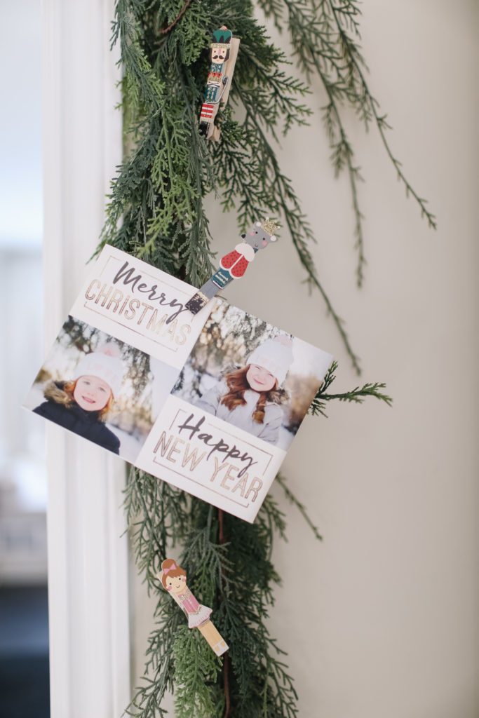 Christmas card attached to garland around a door