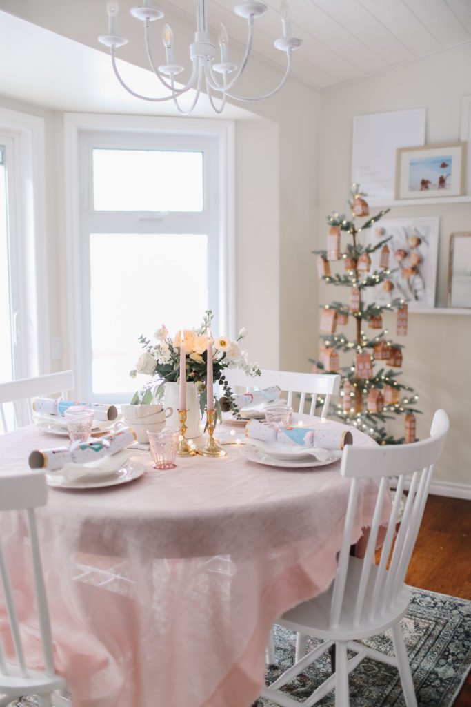 A Christmas dining room table in front of a Christmas tree