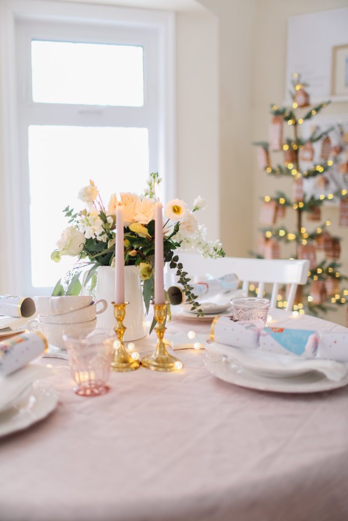 Christmas tablescape with pink flowers and candles