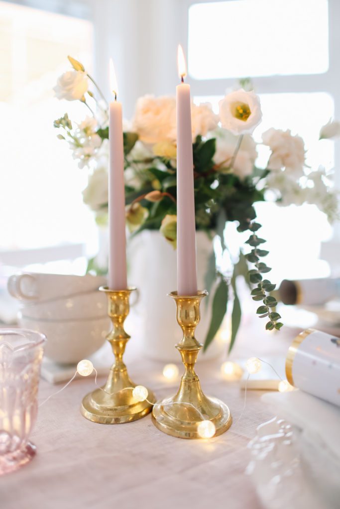 Pink taper candles in vintage brass holders