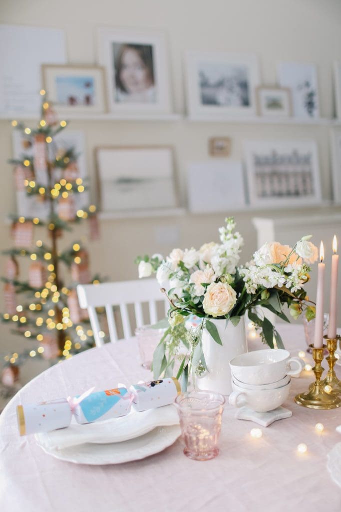 Flowers in front of a lit Christmas tree