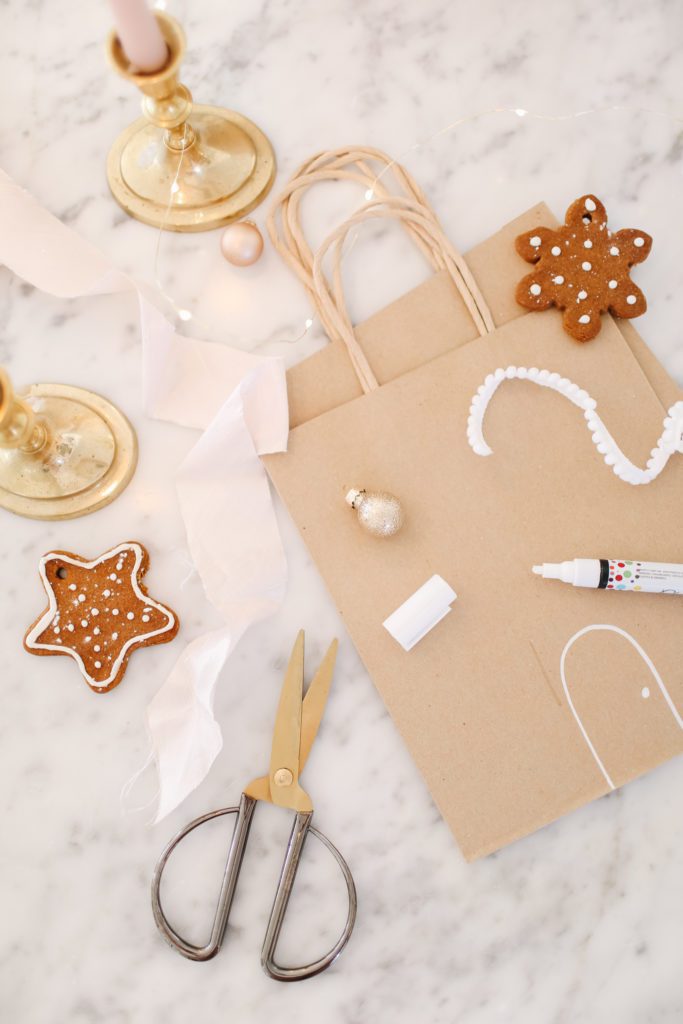 paper bag with ginger cookies ribbon and scissors