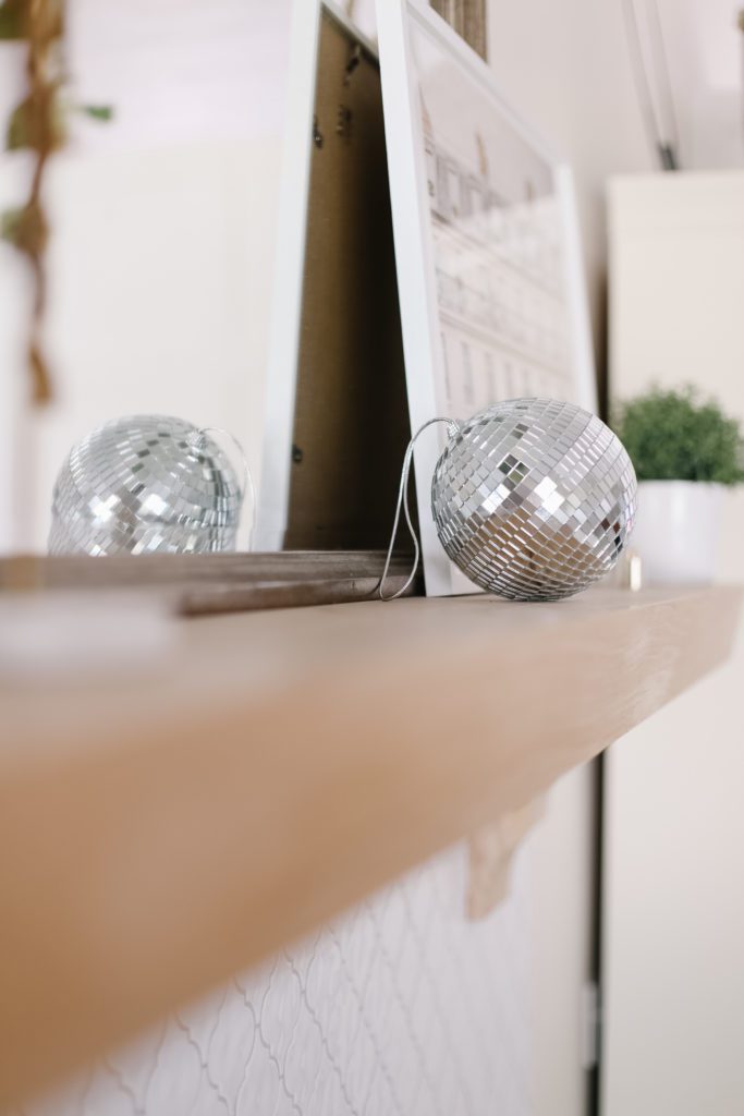 a disco ball sitting on a fireplace mantle
