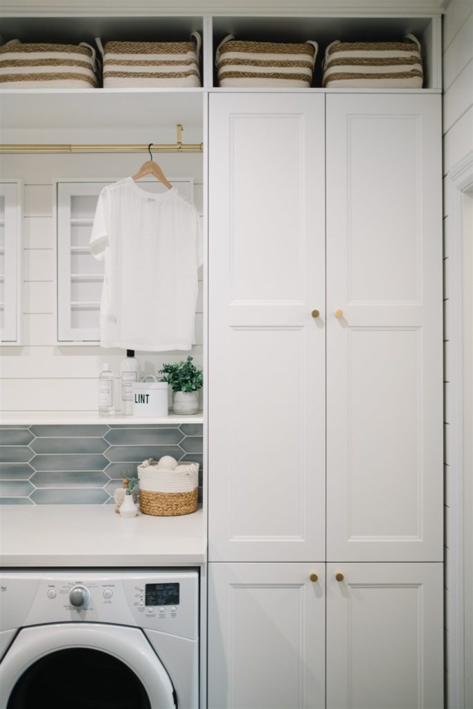 Built in laundry storage, tall white cabinets