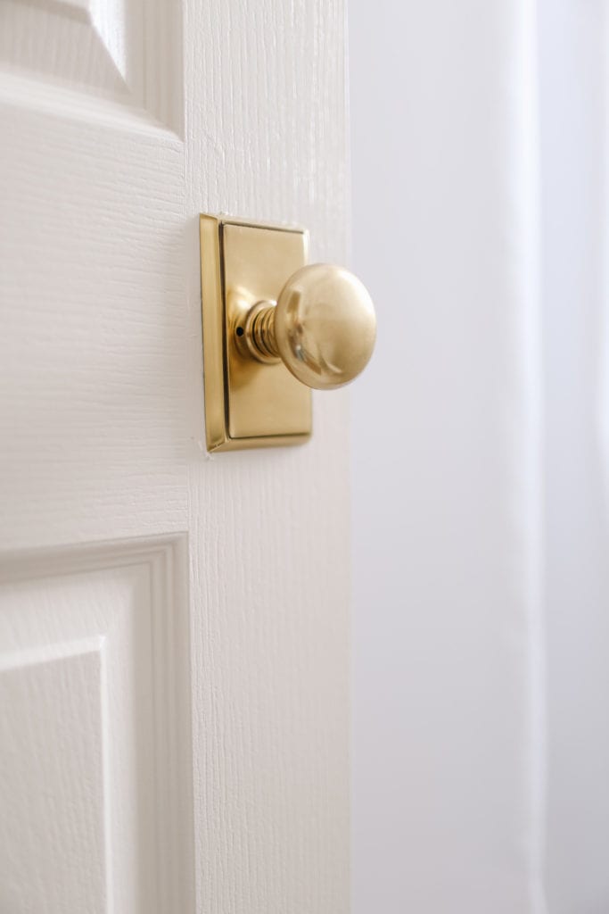 A close up of a round brass door knob