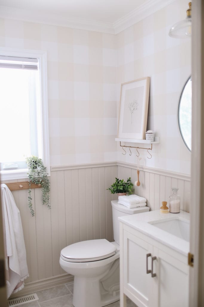 A small bathroom with painted beadboard trim