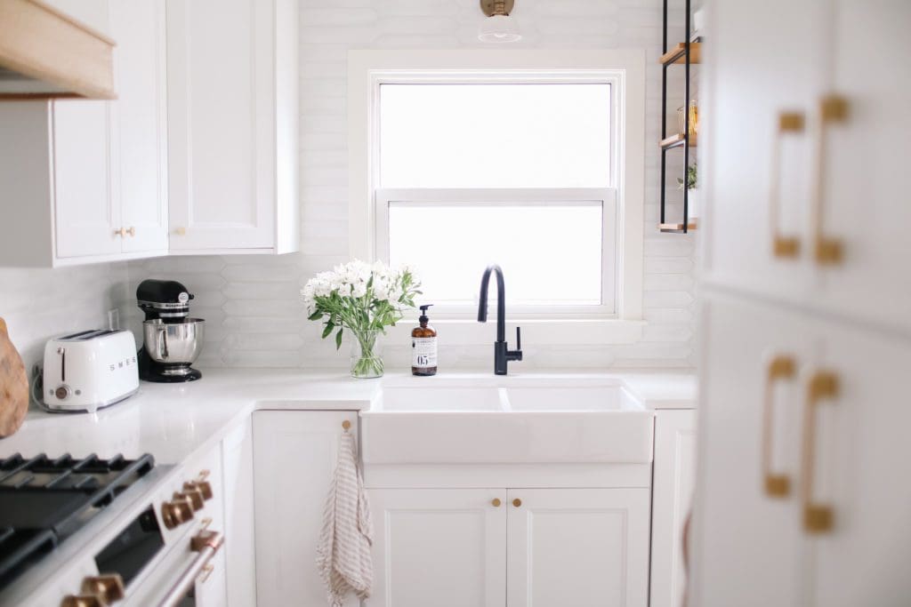 White farmhouse kitchen sink with black faucet