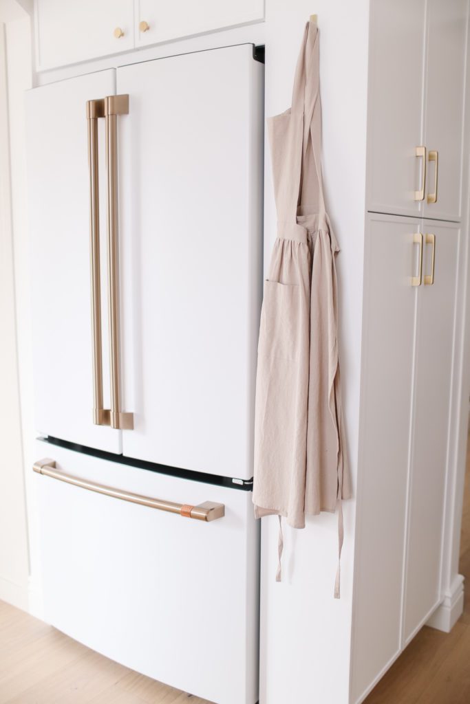 A white fridge with gold handles