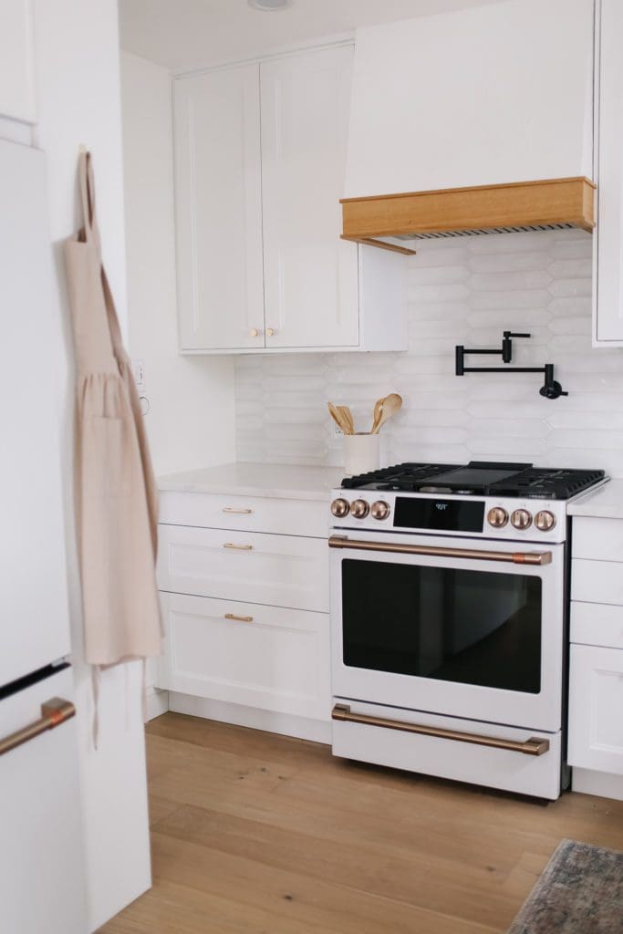 A white and gold Café appliances stove