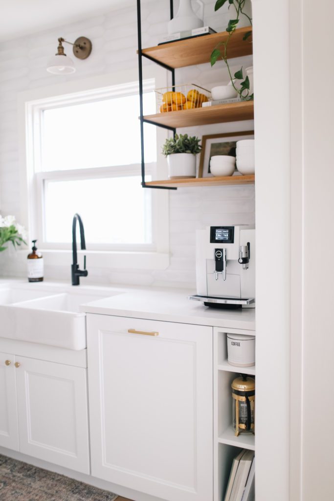 white kitchen cabinets and gold hardware with coffee maker on counter 