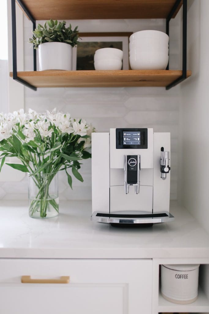 Vase of flowers beside a coffee maker