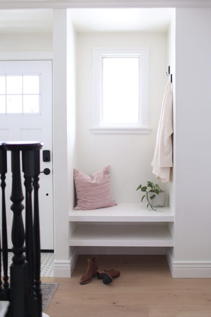 The front entrance nook with built in bench and hooks for jackets.