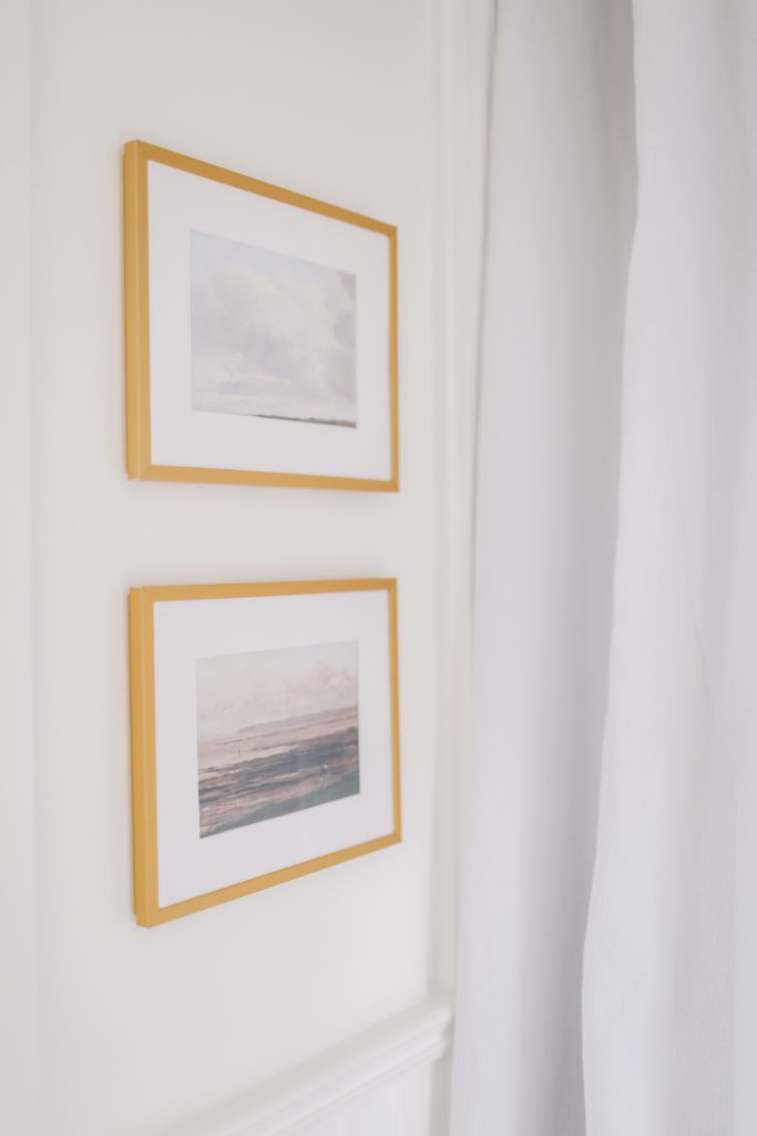 two paintings in gold frames on the wall