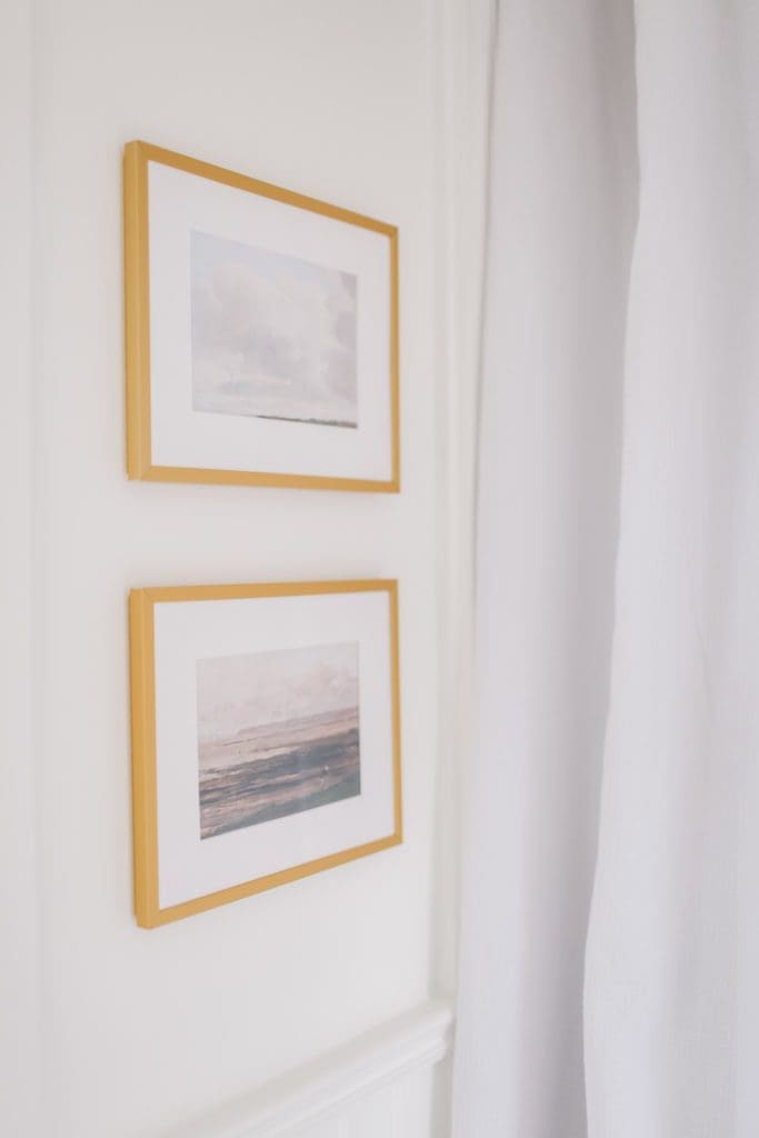 two paintings in gold frames on the wall