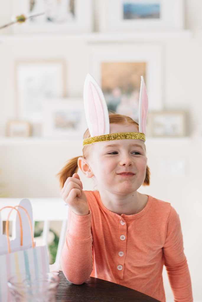a little girl with gold and pink bunny ears