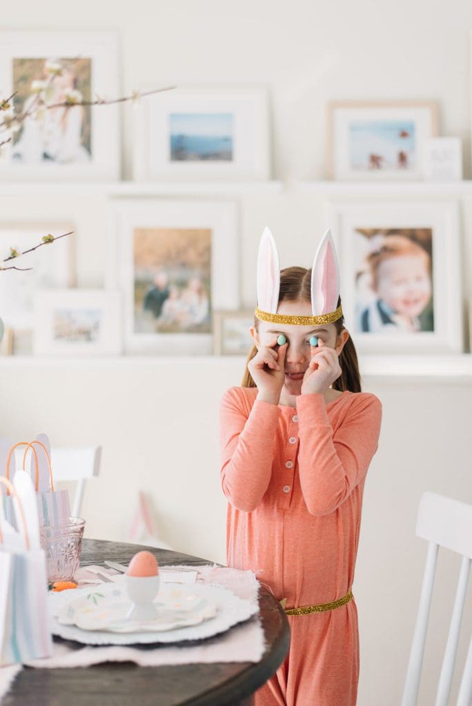 A girl hold Easter mini eggs in front of her eyes