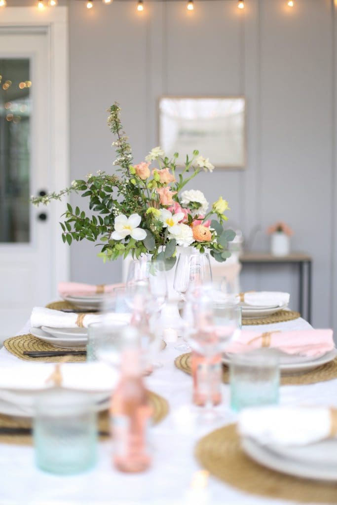 A dining table set with pinks and greens