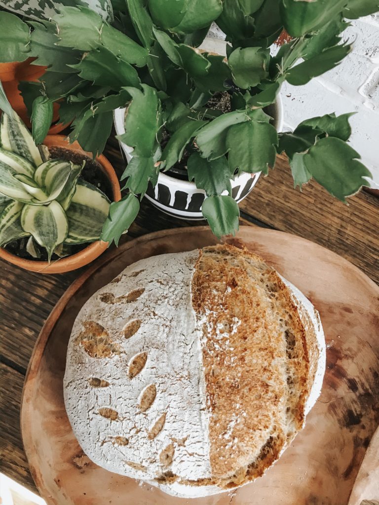 Sourdough bread loaf sitting on top of a wooden table