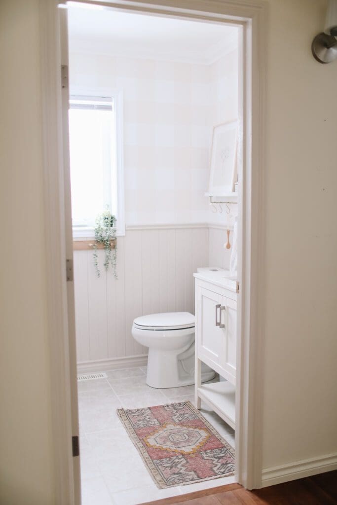 pink vintage rug in front of a bathroom console