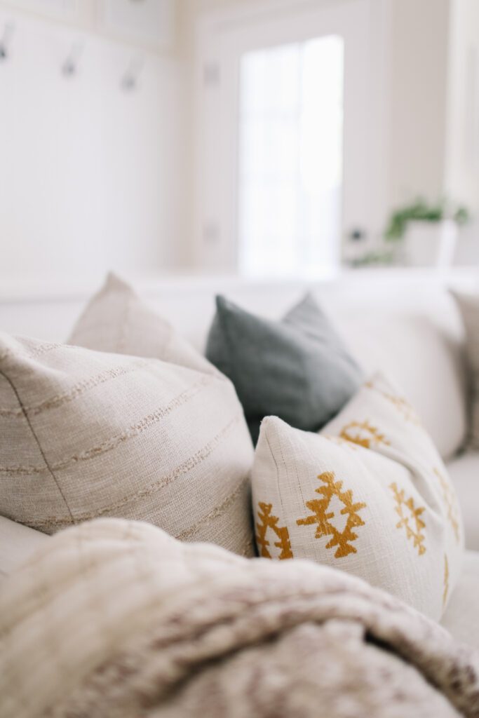 yellow, blue and neutral throw pillows on a couch