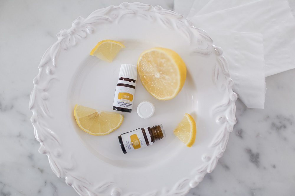 lemon essential oil, good for stopping nosebleeds on a white plate